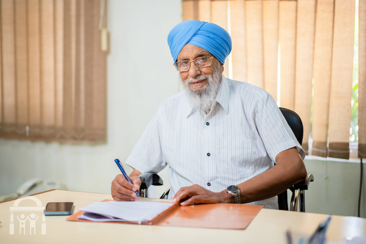 Amarjit Singh Klare at desk - Guru Nanak Mission Hospital Dhahan Kaleran Trustee - Treasurer