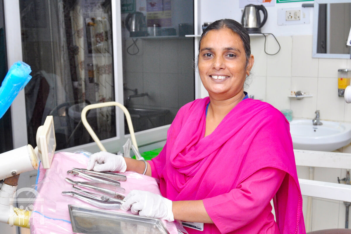 Dental assistant at table with dental tools at Guru Nanak Mission Hospital Dhahan Kaleran near Banga in Punjab