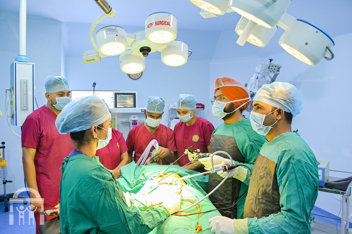 Surgical team performing laparoscopic surgery viewing screen at Guru Nanak Mission Hospital Dhahan Kaleran near Banga in Punjab