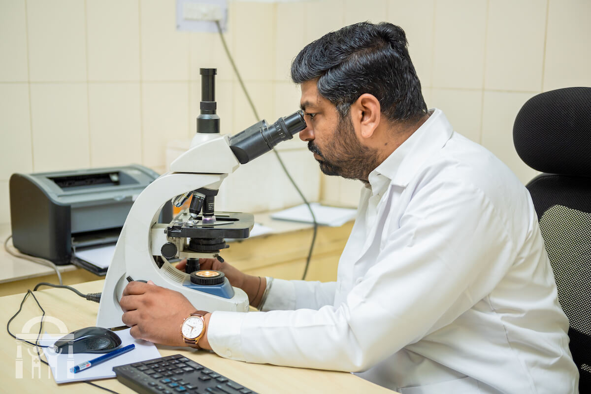 Pathologist working with microscope at Guru Nanak Mission Hospital Dhahan Kaleran near Banga