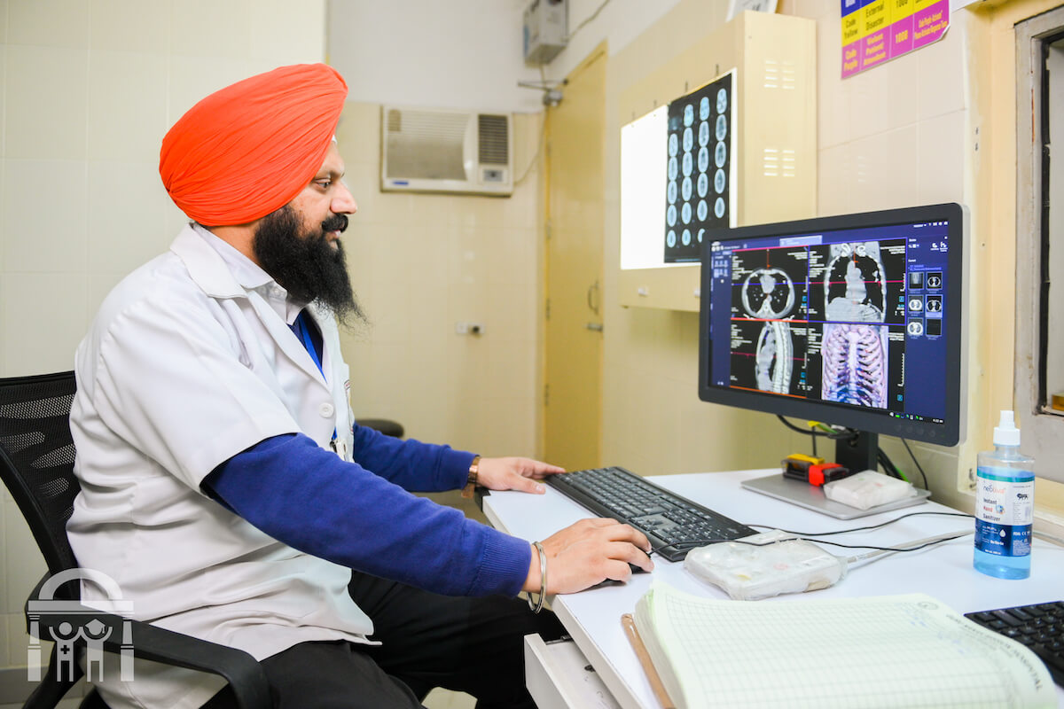 Radiology department - viewing scans on computer at Guru Nanak Mission Hospital Dhahan Kaleran