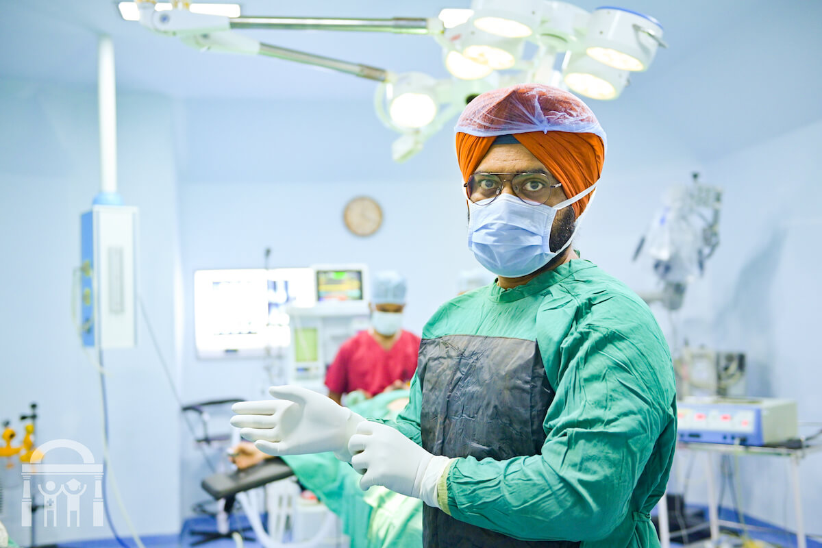 Surgeon wearing gloves and mask in operating theatre at Guru Nanak Mission Hospital Dhahan Kaleran near Banga in Punjab